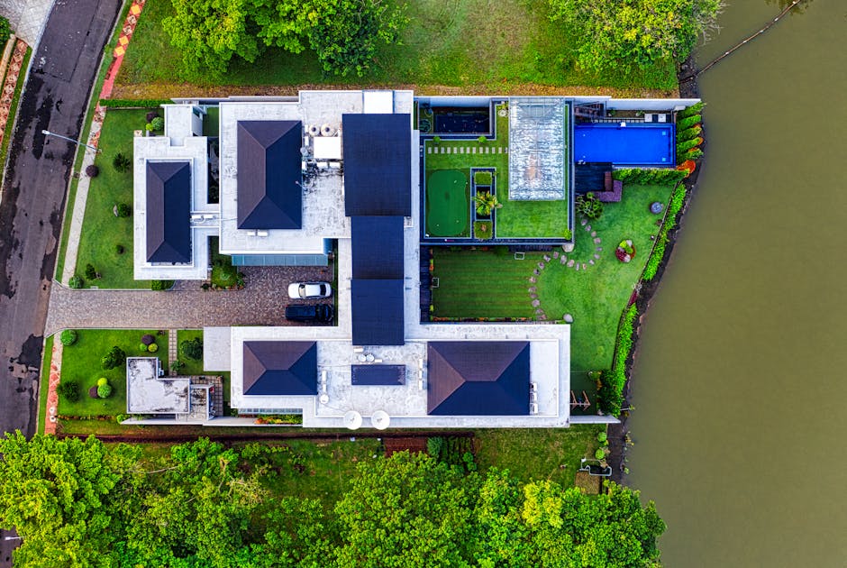 A stunning aerial view of a modern mansion in Banten, Indonesia, showcasing its architectural design and scenic surroundings.